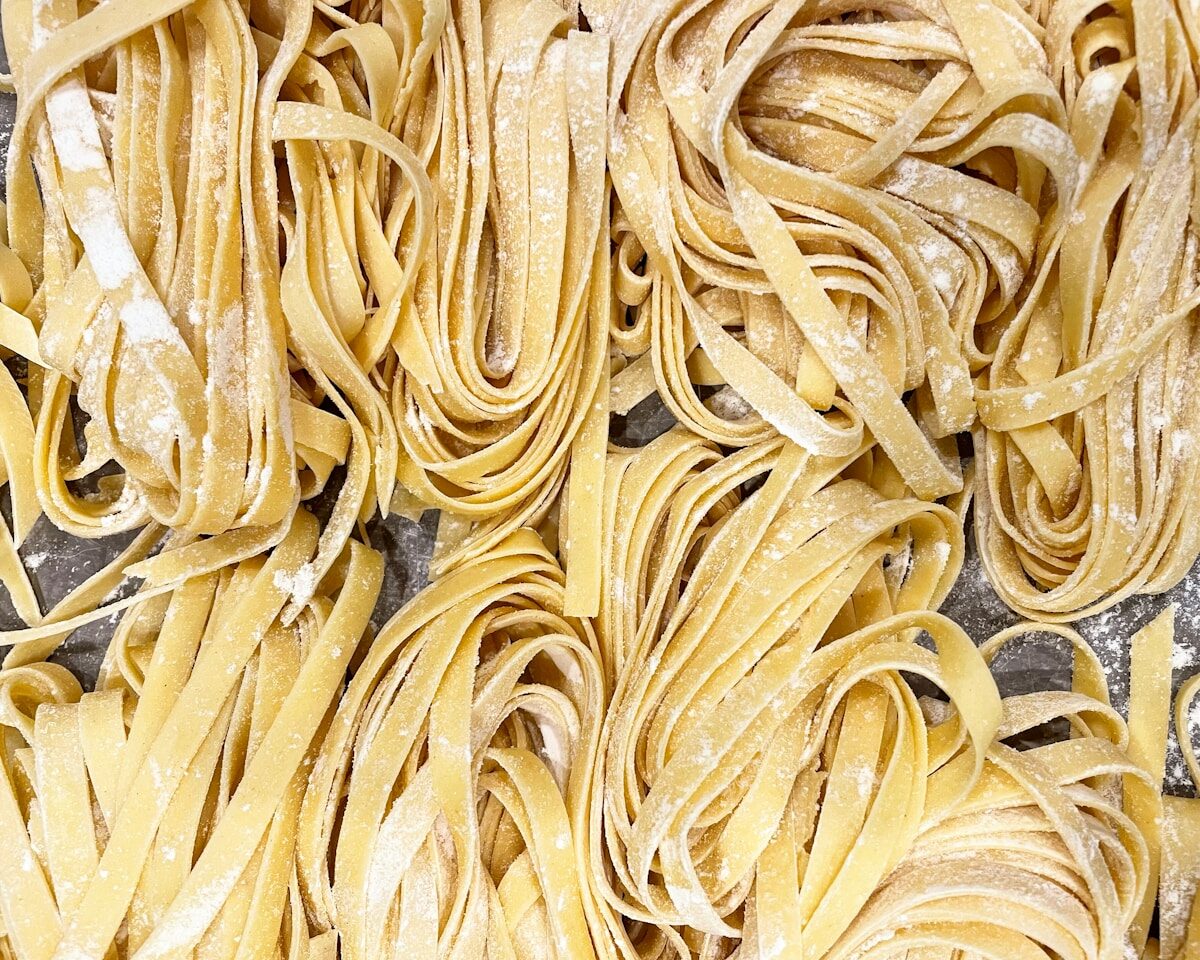 yellow pasta on stainless steel tray