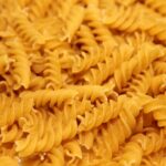 yellow pasta on black background
